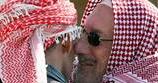 Iraqi Sunni and Shi'ite Sheiks kiss, by Drew Brown. Used with permission by S&S. © 2010 Stars and Stripes